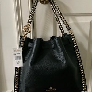 MK Mina black leather shoulder bag.